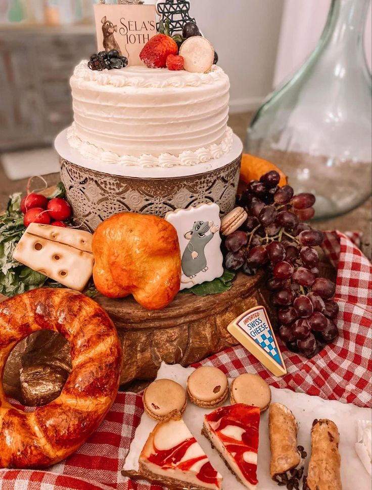 a table topped with lots of different types of food on top of a red and white checkered table cloth