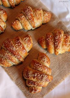 several croissants are lined up on a table with powdered sugar sprinkled on them