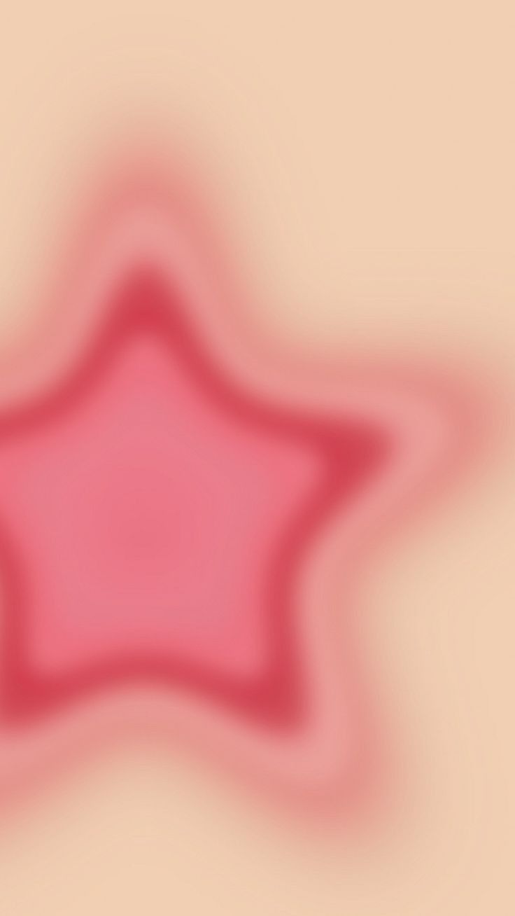 a blurry image of a pink star on a beige background with red and white colors