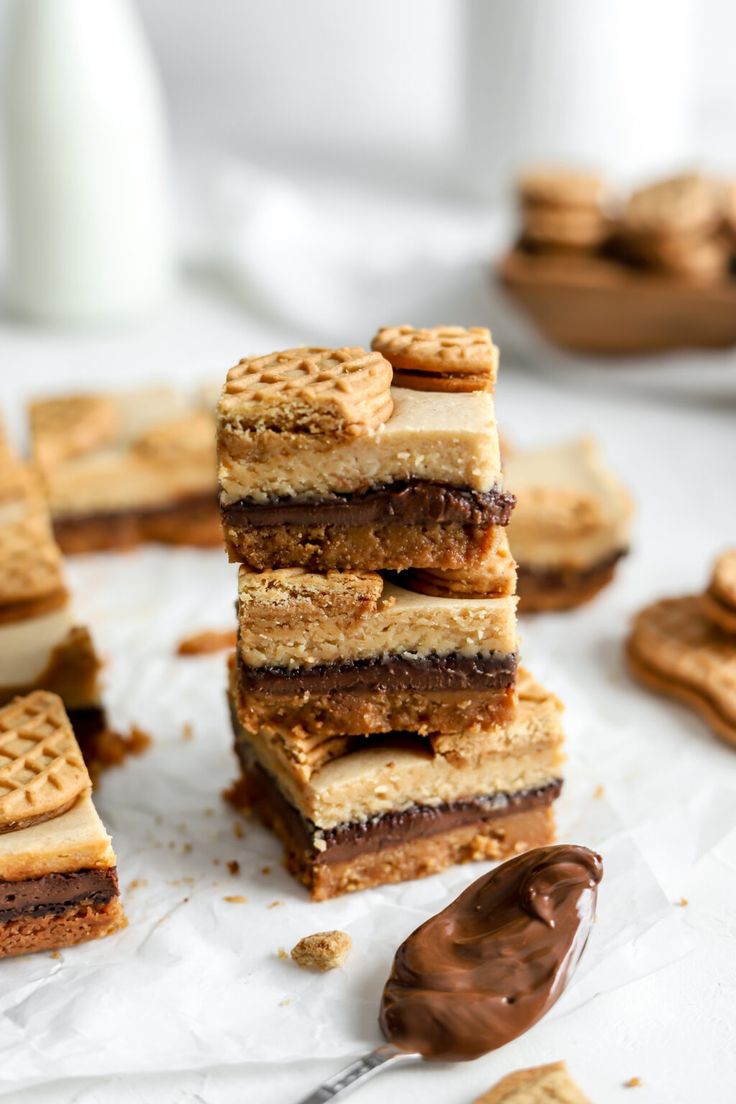 a stack of crackers sitting on top of each other next to a chocolate covered cookie