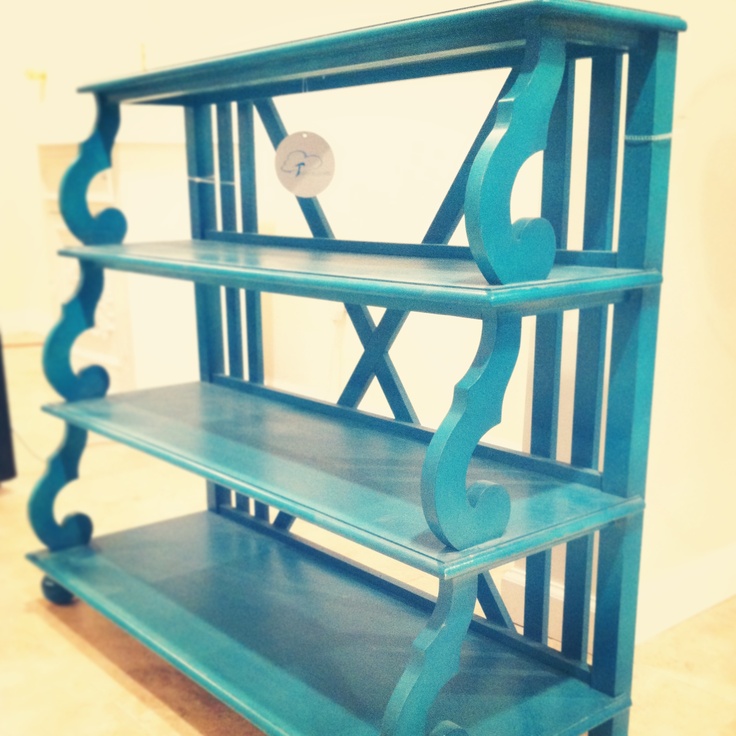 a blue shelf sitting on top of a hard wood floor