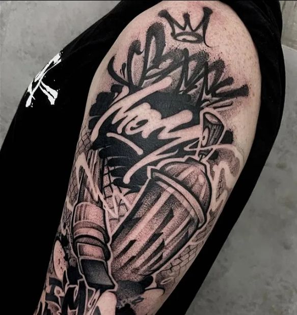 a man's arm with some tattoos on it