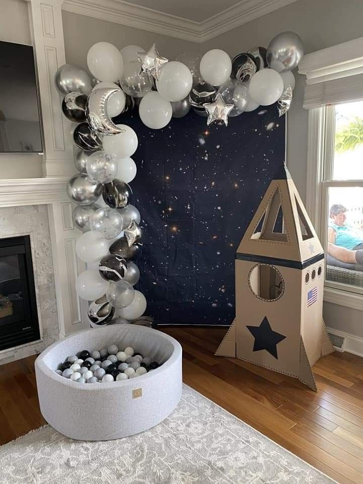 a room decorated with balloons and a clock tower