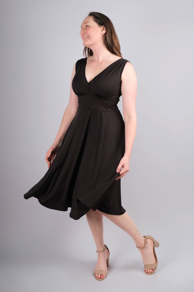 A stunning, simple, solid black dress Crossover V neckline in front and back of bodice Sleeveless Flattering waistband that falls underneath your bust line Midi length skirt falls to your mid calf Made from wrinkle free, stretch microfiber (Polyester/Spandex blend) Proudly made in the U.S.A. Abigail Dress Length: XS: 46" - S/M: 46.5" - M/L: 47" - XL: 47.5" - XXL: 48" Meet The ModelName: Laurel Karina Size: M/L Abigail Dress, Midi Length Skirts, Fall Skirts, V Neckline, Wrinkle Free, Mid Calf, Everyday Life, Solid Black, Midi Length