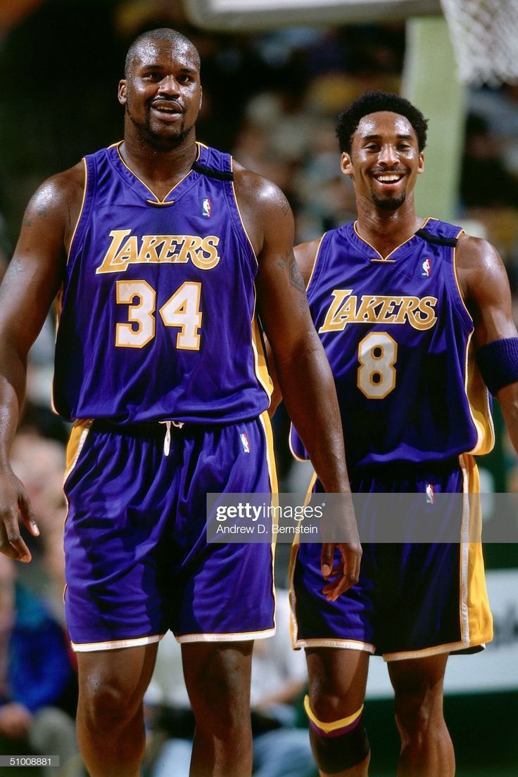 two basketball players standing next to each other