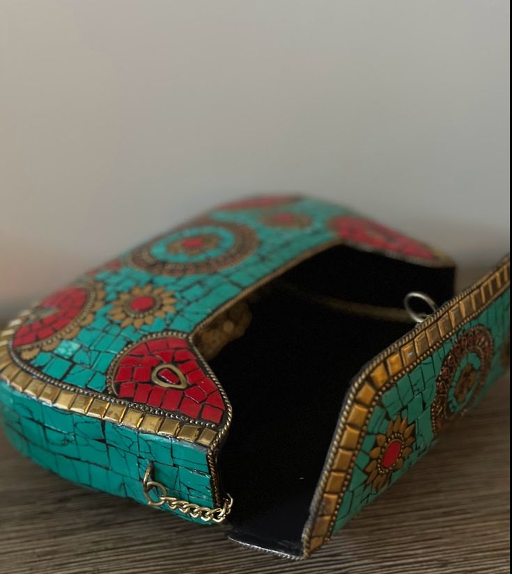 This statement green clutch is a true work of art, crafted with meticulous attention to detail. It showcases a mesmerizing design composed of vibrant, colorful mosaic patterns that catch the eye and add a touch of elegance to any outfit. At Indus Threads, we believe that accessories should not only be functional but also make a bold fashion statement. That's why our Mosaic Purse stands out from the crowd with its distinct and captivating aesthetic. It is designed to be a versatile accessory, per Artisan Multicolor Clutch As A Gift, Artisan Multicolor Rectangular Clutch, Bohemian Multicolor Rectangular Clutch, Green Rectangular Clutch Gift, Green Rectangular Clutch As Gift, Rectangular Green Clutch For Gift, Green Rectangular Clutch For Gift, Handmade Multicolor Rectangular Clutch, Bohemian Rectangular Shoulder Bag For Formal Occasions