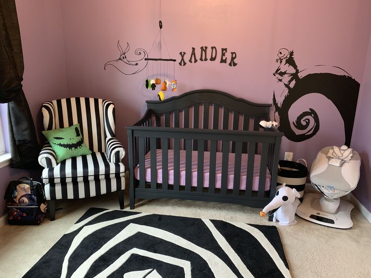 a baby's room decorated in black and white with striped furniture, walls painted pink