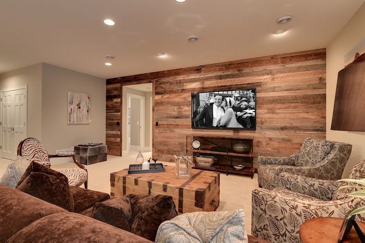 a living room filled with furniture and a flat screen tv mounted on the wall over a fire place