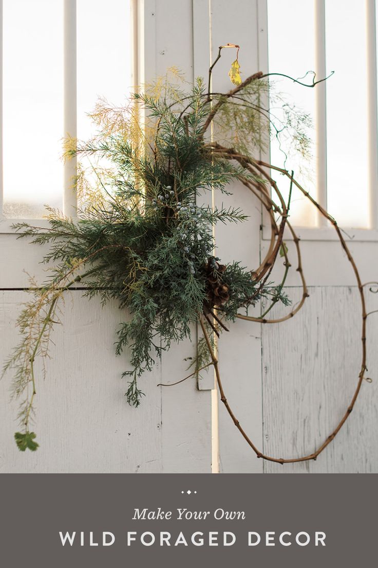 a wreath hanging on the side of a white door with text that reads make your own wild foraged decor