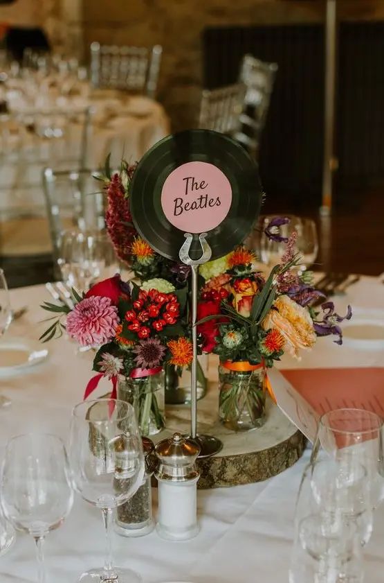 the table is set up with flowers and wine glasses for guests to sit down at