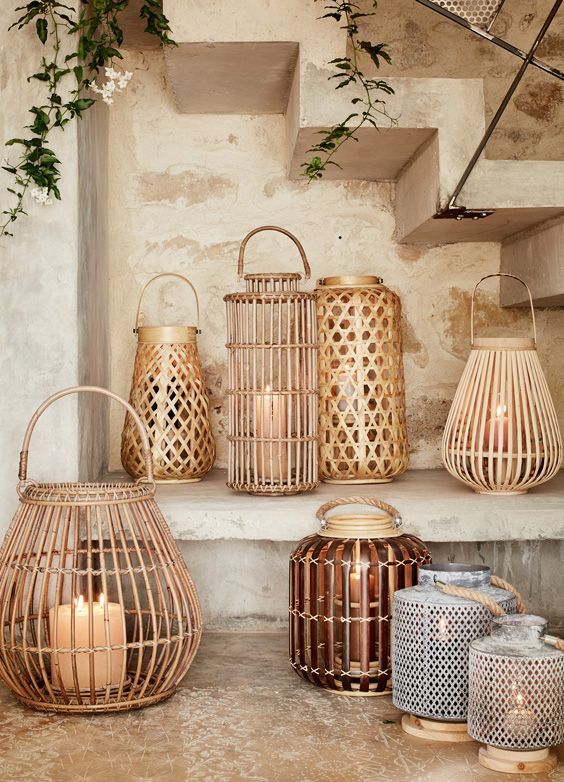 decorative lanterns are lined up on a shelf