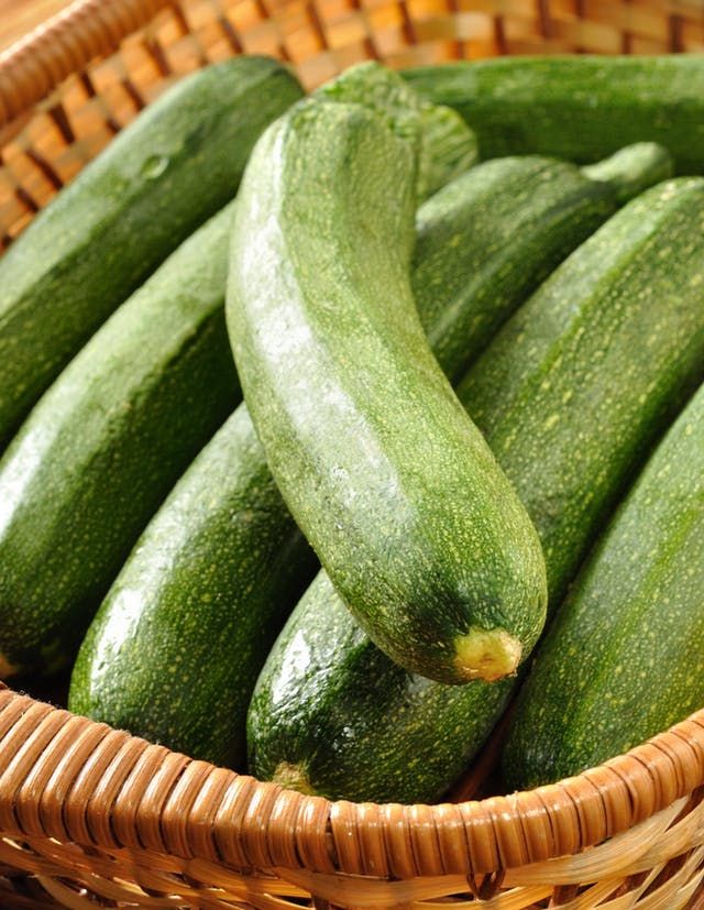 cucumbers in a wicker basket on a table