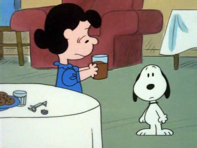 a cartoon character is holding a glass in front of a snoopy sitting at a table