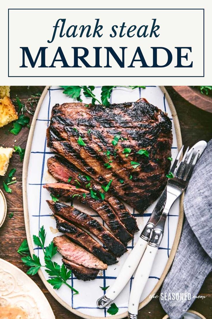 flank steak marinade on a white plate with parsley garnish and fork