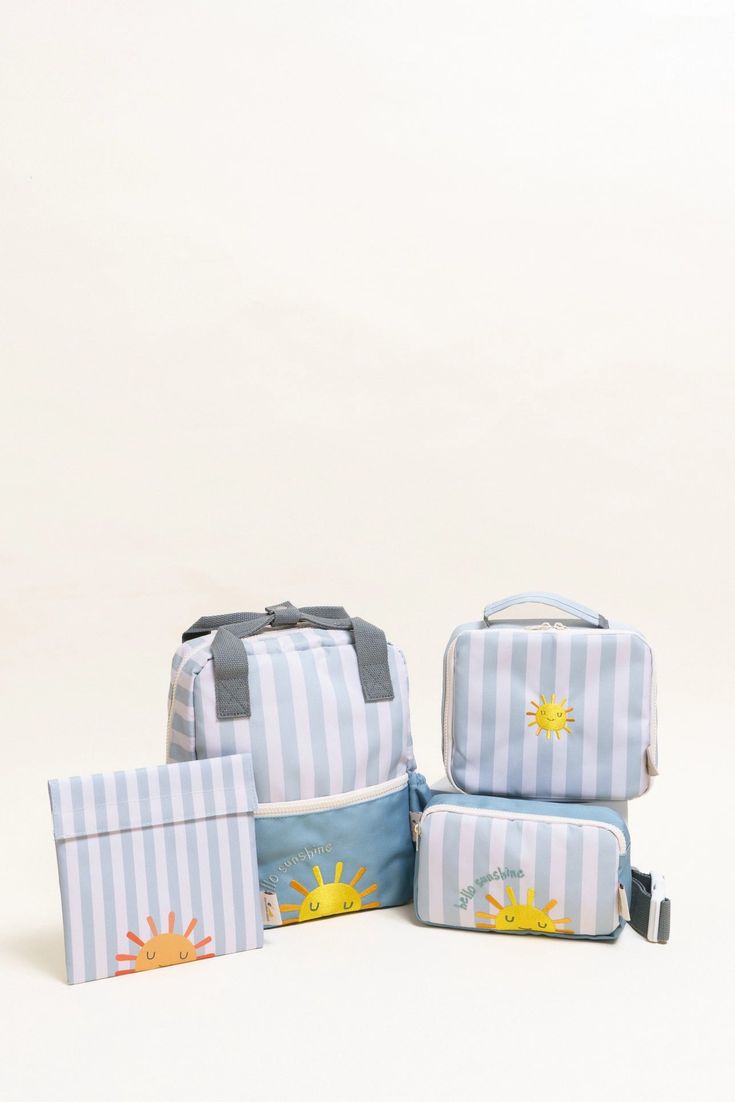 four pieces of luggage sitting next to each other on a white surface with sunflowers painted on them