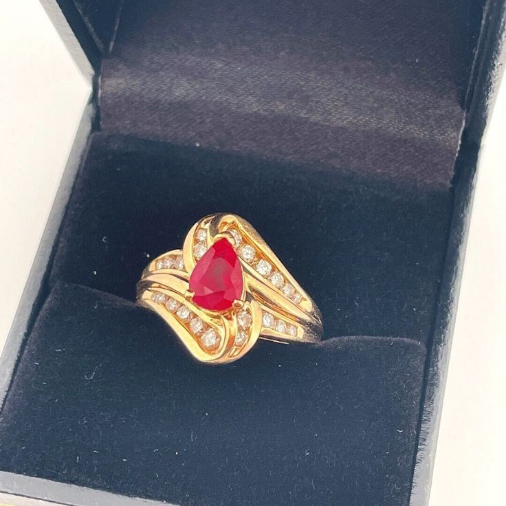 Appraisal Report included with your purchase.  Here we have a superb natural earth mined ruby and sparkly diamond ring circa 1970.  This exceptional vivid red ruby ring is a size 5 1/4 US.  In total it weighs approximately 5.5 grams. The ruby and diamond set face of the ring measures 9/16" long down the finger with a rise of 5/16" off the hand (15mm, 8mm).  It is in lovely condition and is ready to gift or to wear.  The fine gem quality ruby in this ring is a gorgeous color being a vivid red and Teardrop Hallmarked Ring For Anniversary, Yellow Gold Teardrop Sapphire Ring For Anniversary, Teardrop Yellow Gold Sapphire Ring For Anniversary, Teardrop Sapphire Ring In Yellow Gold For Anniversary, Hallmarked Teardrop Anniversary Ring, Anniversary Yellow Gold Teardrop Sapphire Ring, Fine Jewelry Pear-shaped Yellow Gold Birthstone Ring, 14k Gold Pear-shaped Ruby Ring For Anniversary, 14k Gold Pear-shaped Rings With Accent Stones