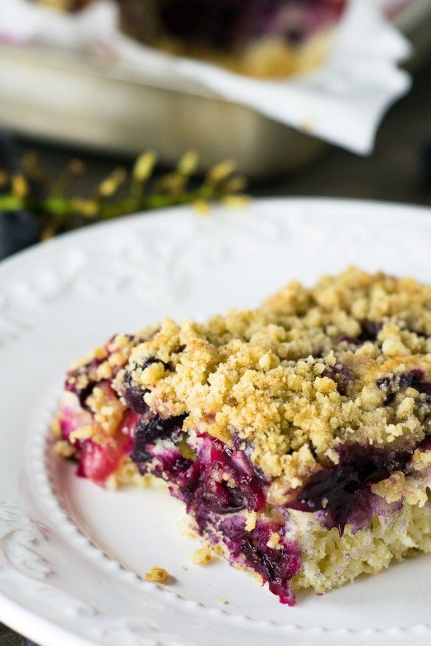 a piece of blueberry crumb cake on a white plate