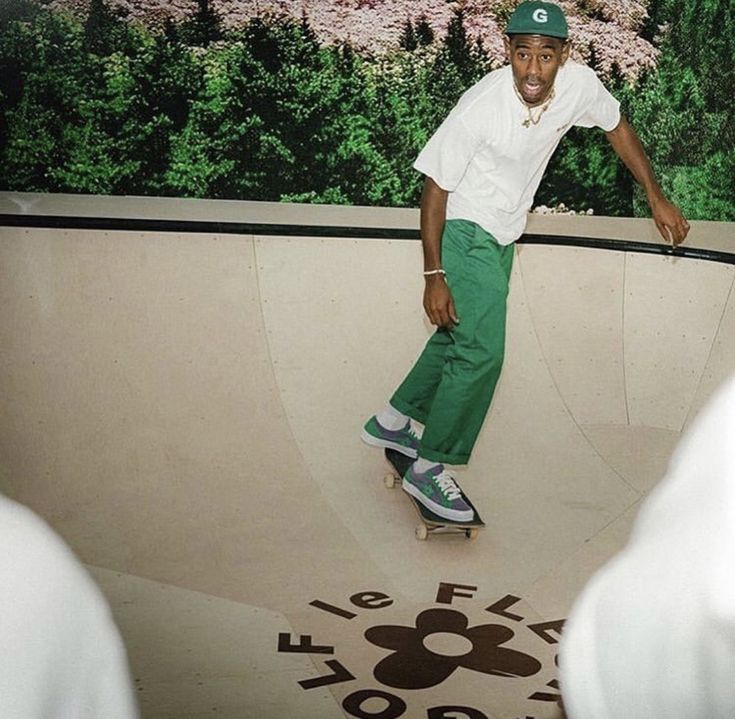 a man riding a skateboard up the side of a ramp at a skate park