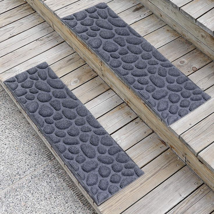 two mats sitting on top of a wooden floor