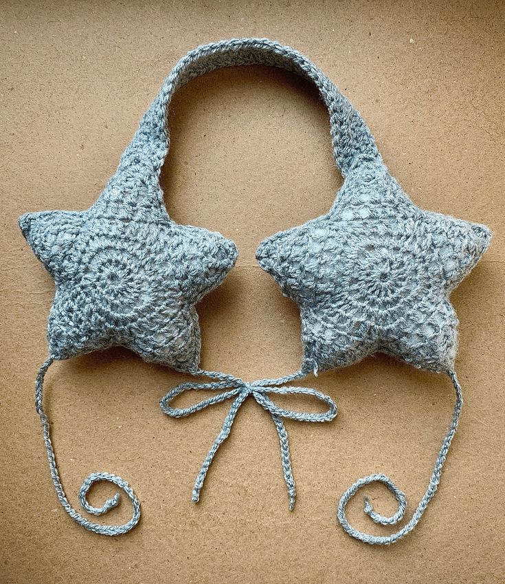 two blue knitted stars on top of each other