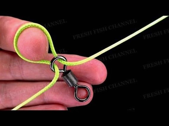 a hand holding a pair of scissors on a string