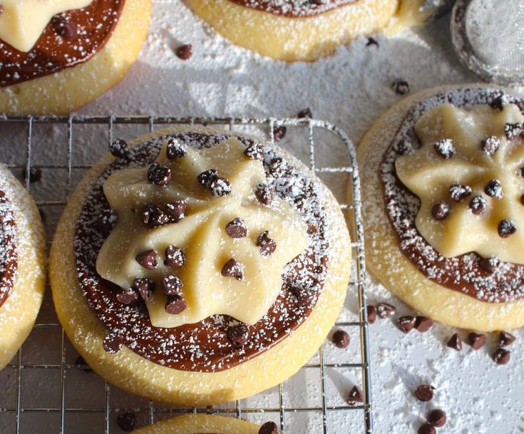 cookies with icing and chocolate chips on a cooling rack