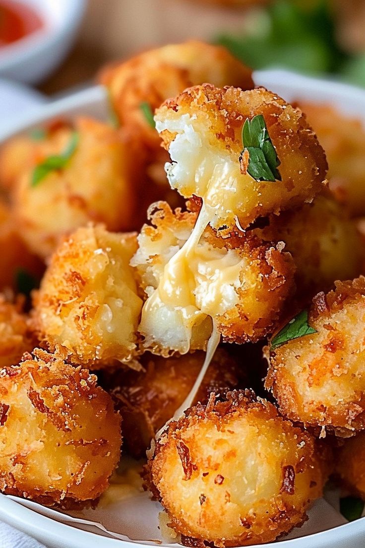 a white bowl filled with fried food on top of a table