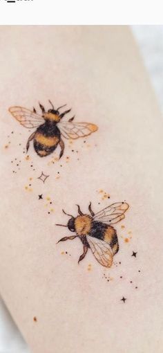 two bums on the side of a woman's thigh with stars around them