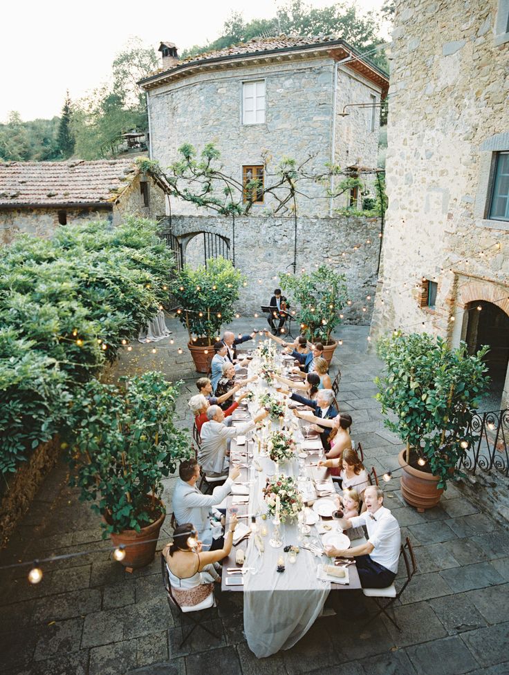 a group of people sitting around a long table