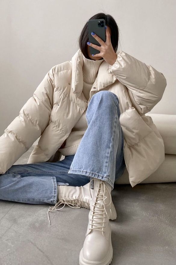 a woman is sitting on the floor with her hands up to her face