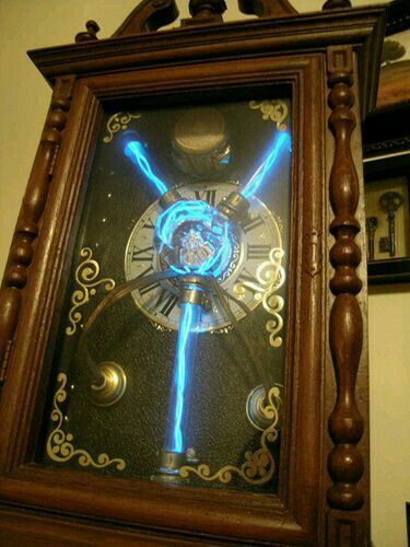 an old clock with blue lights on it's face in a wood frame hanging from the wall