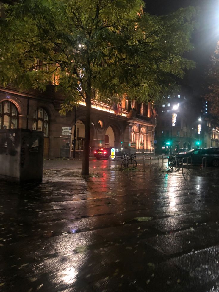 a city street at night in the rain