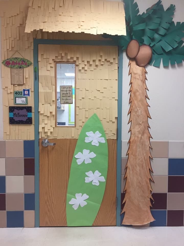 a paper palm tree next to a door with a surfboard on the front and side