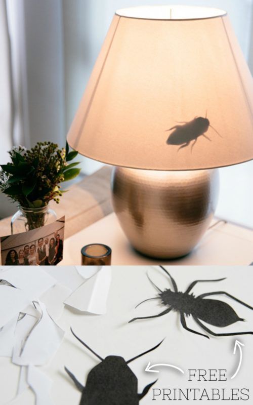 a lamp that is sitting on top of a table with paper cut out of it