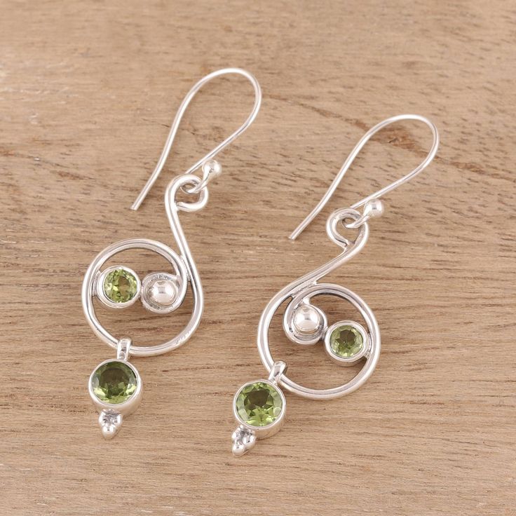 Crafted from sterling silver, swirling patterns offer a royal aesthetic to this pair of dangle earrings from India. Presented by Shanker, this accessory features gemstones of faceted green peridot. Elegant Green Spiral Jewelry, Ad Earrings, Royal Aesthetic, Chalcedony Earrings, Peridot Earrings, Large Necklace, Onyx Earrings, Sterling Silver Dangle Earrings, Green Peridot