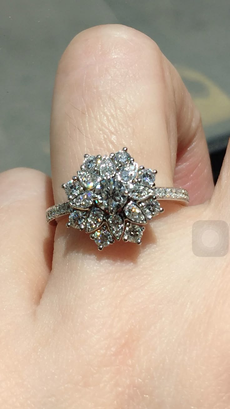 a woman's hand with a diamond ring on it