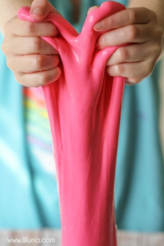 a close up of a person holding a pink object