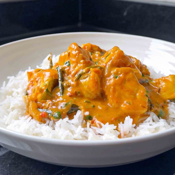 a white bowl filled with rice and chicken curry