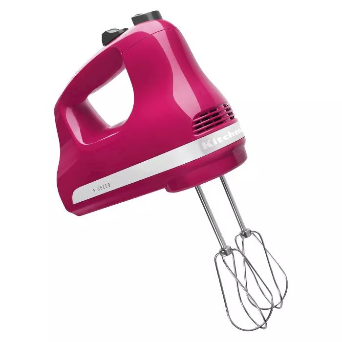 a pink hand mixer on a white background