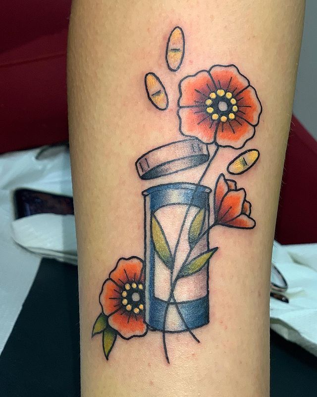 a tattoo with flowers and a vase on the side of a woman's leg