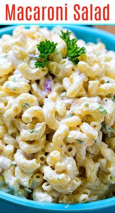 macaroni salad in a blue bowl with parsley on top and text overlay