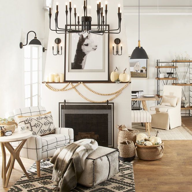 a living room filled with furniture and a fire place in front of a painting on the wall