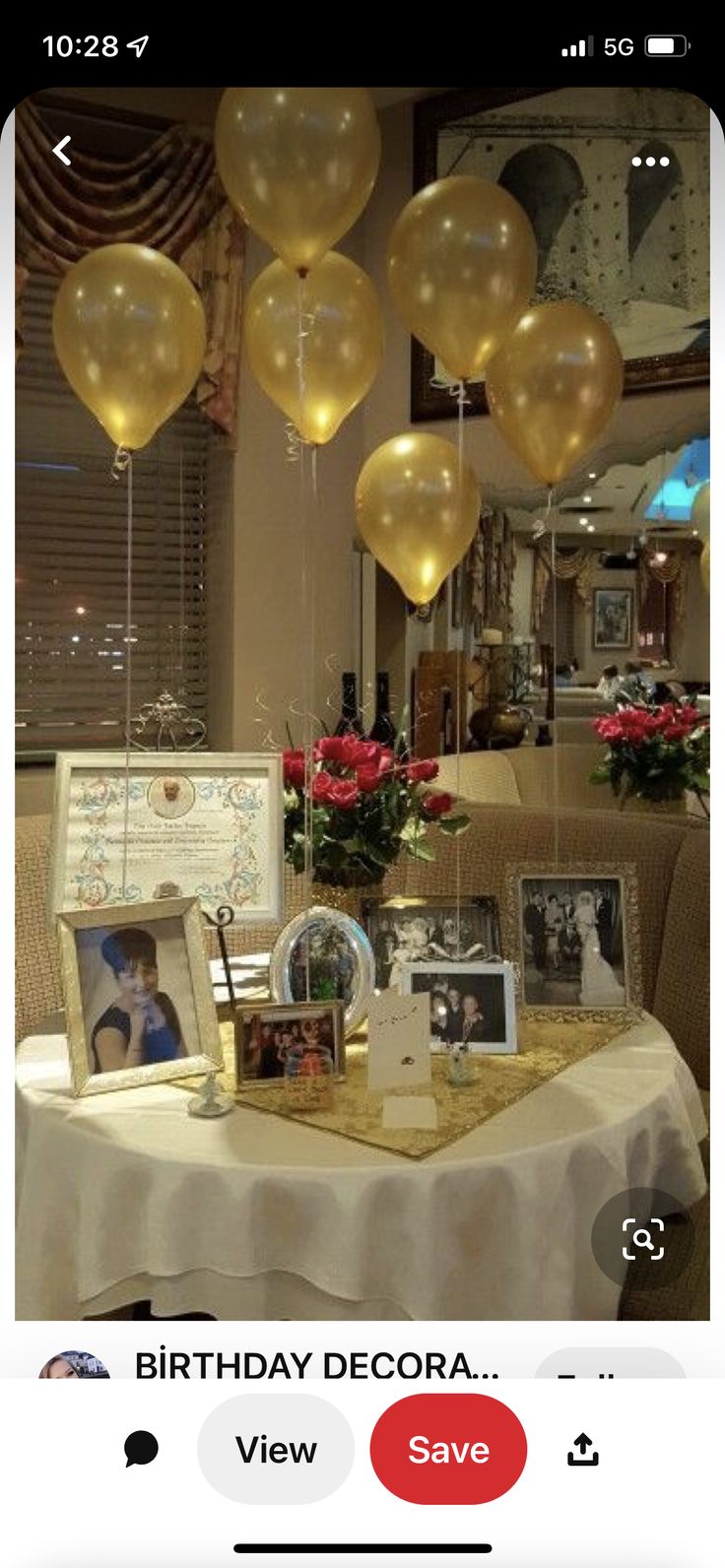 a table with balloons and pictures on it