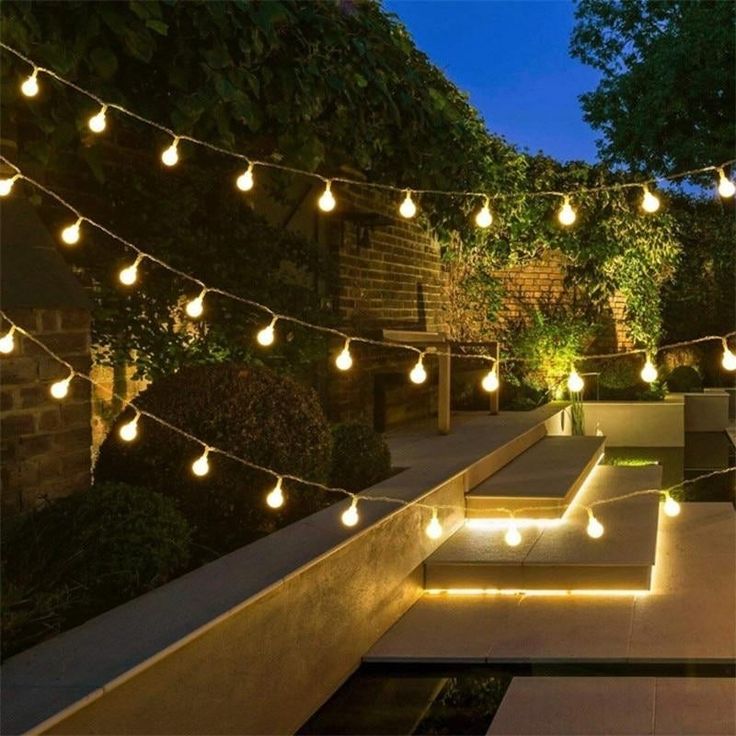 an outdoor patio with lights strung over it