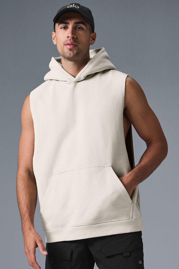 Stay cozy without sacrificing style in the Renown Sleeveless Hoodie. It has deep armholes, a kangaroo pocket, and a laid-back cut. And wait till you feel the Alo signature Renown fabric—it's smooth on the outside, a little fleecy on the side, and heavyweight for a just-right drape. Add shorts and you’re covered from the gym to the street. Alo Yoga Cotton Tops For Fall, Cotton Hoodie With Pockets For Gym, Casual Streetwear Vest With Dropped Armholes, Fall Gym Tops With Pockets, Alo Yoga Cotton Hoodie In Athleisure Style, Alo Yoga Athleisure Tops For Streetwear, Cotton Hoodie Activewear With Pockets, Sleeveless Cotton Hoodie For Fall, Cotton Activewear Hoodie With Pockets