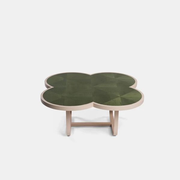 a green table with two leaves on top and one leaf shaped design in the middle