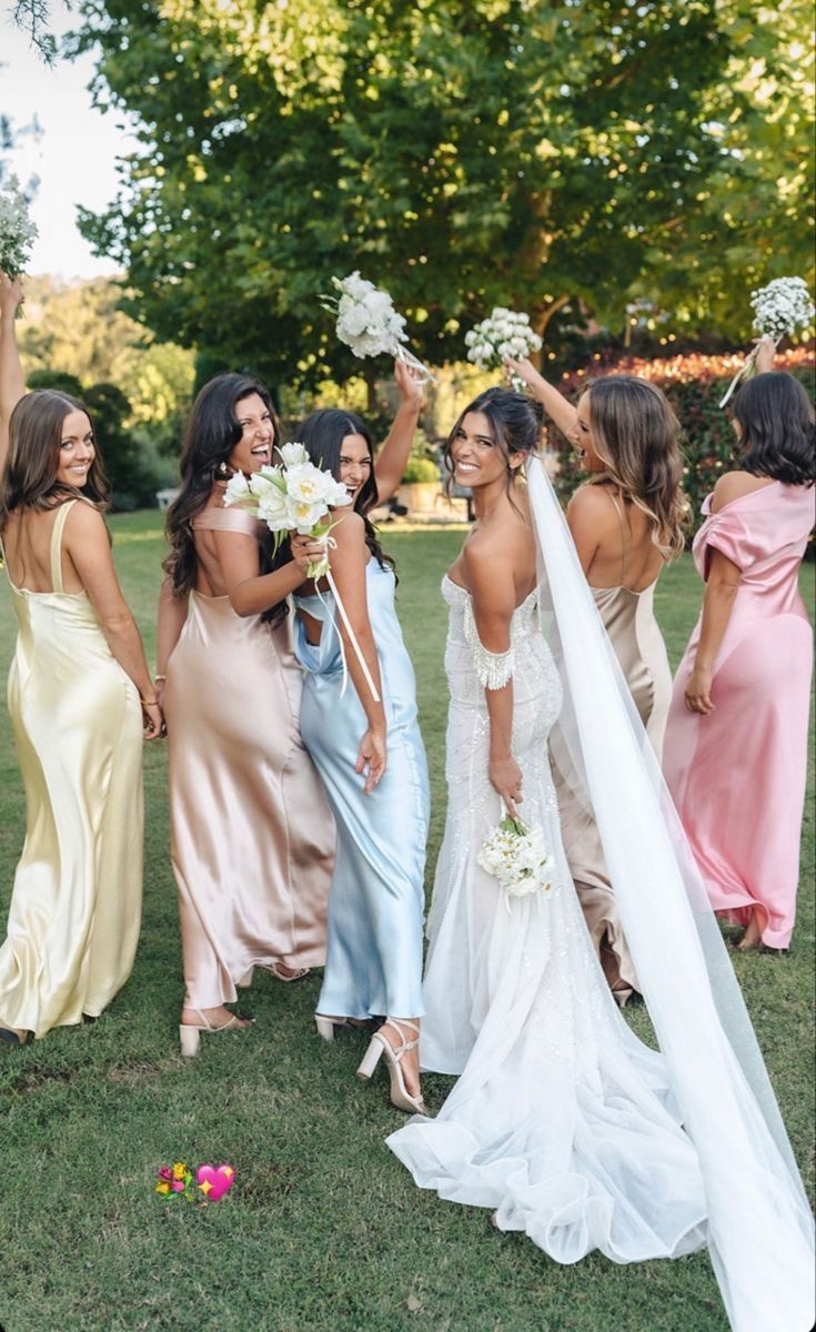 a group of women standing next to each other on top of a lush green field