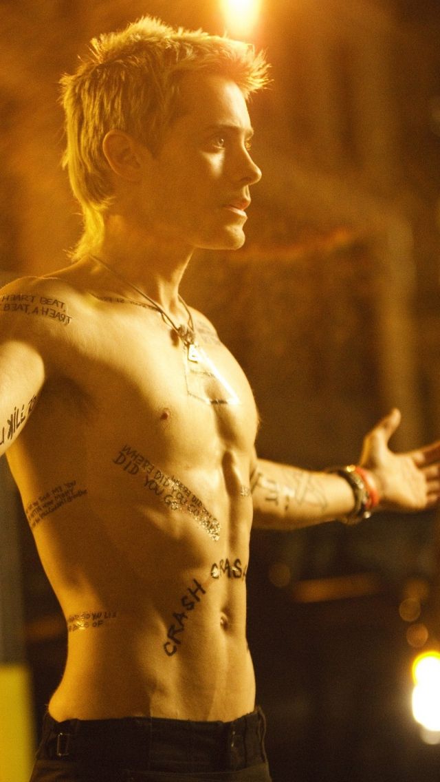 a man with tattoos standing in front of a camera and the words,'what is my friend?'written on his chest