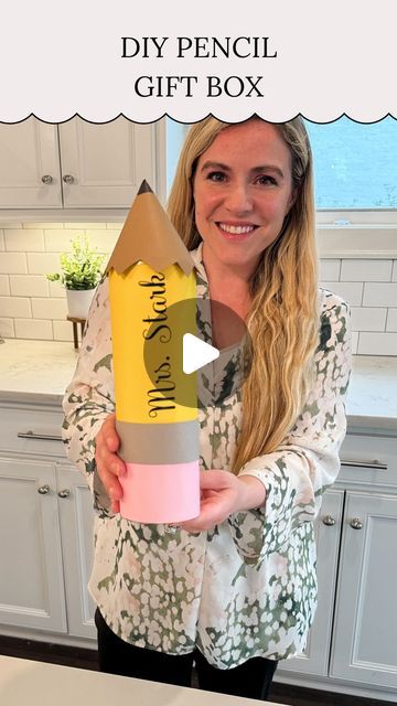 a woman holding up a pencil gift box in her kitchen with the words diy pencil gift box written on it