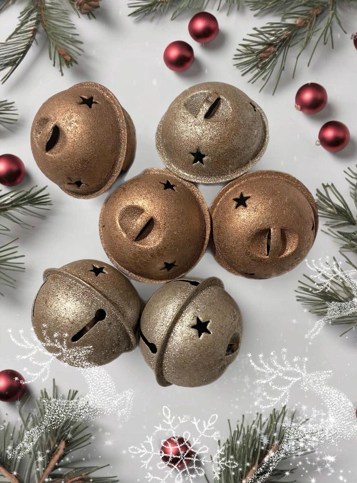 four bells with faces are surrounded by christmas decorations